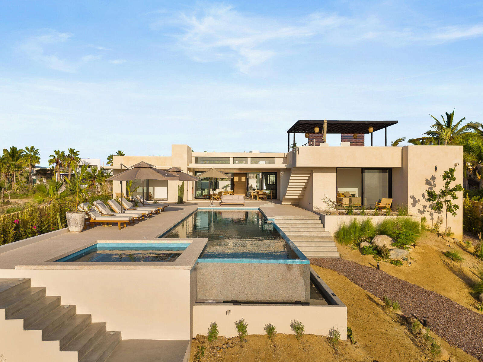 Cabo Luxury Las Tunas The Nacuii Residence is a refined luxury home crafted to exceed the expectations of even the most discerning buyer. Nestled on a generous and private 3,000 mยฒ lot (0.73 acres), it's just a short, effortless stroll to the untouched, sandy shores of Las Tunas โ perfect for enjoying the serene coastal landscape and dramatic sunsets. The home offers a thoughtful layout with 3 spacious bedrooms, a separate studio, a cozy TV lounge, and 6 full bathrooms, including two principal suites, a guest room, a detached studio, and a dedicated media or family room. Expansive sliding glass doors invite natural light throughout the interiors while showcasing tranquil garden for sale