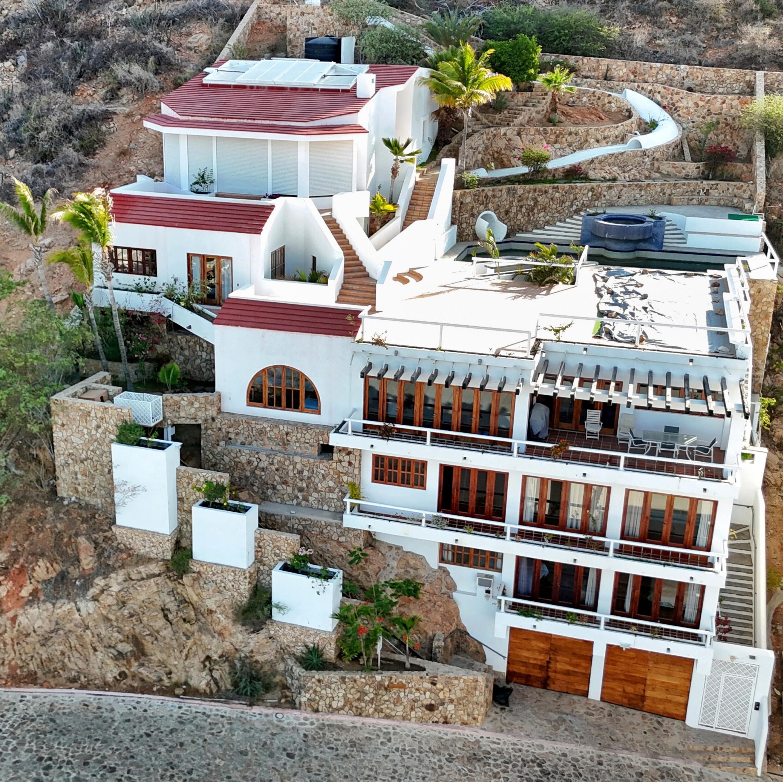 Cabo Luxury Pedregal Csl Perched high above the marina and the Sea of Cortez, this extraordinary 10,000-square-foot estate is one of Pedregal's most iconic residences. Carved into the granite hillside, the property represents a remarkable piece of Cabo San Lucas history and offers an architectural experience unlike any other in Los Cabos.Panoramic for sale